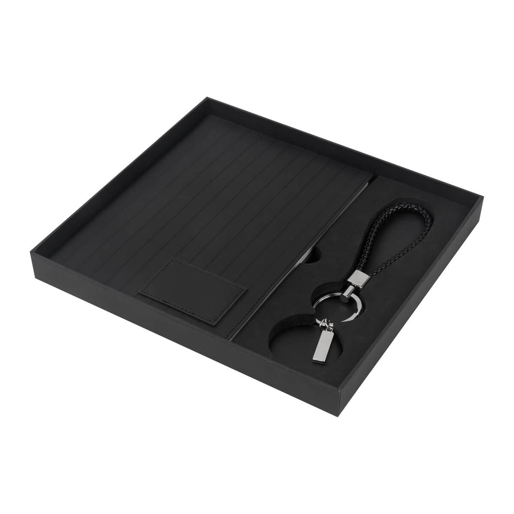 Kit ejecutivo personalizado con libreta de curpiel, llavero premium y caja de regalo para empresas.